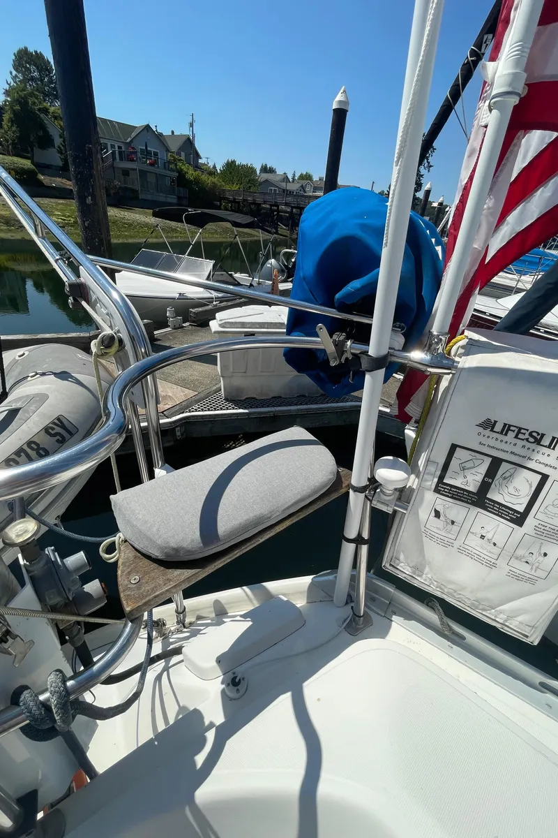 Slide: The Image of Jeanneau Sun Odyssey 36 sailboat deck, featuring safety equipment and docked in a marina, 1990 model. - 22
