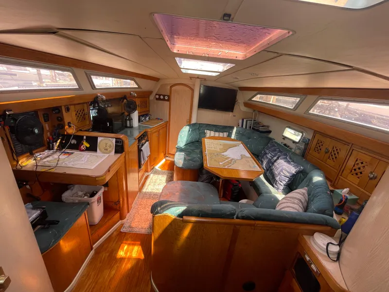 Slide: The Image of Interior of 1990 Jeanneau Sun Odyssey 36 sailboat with cozy seating and navigation area. - 25