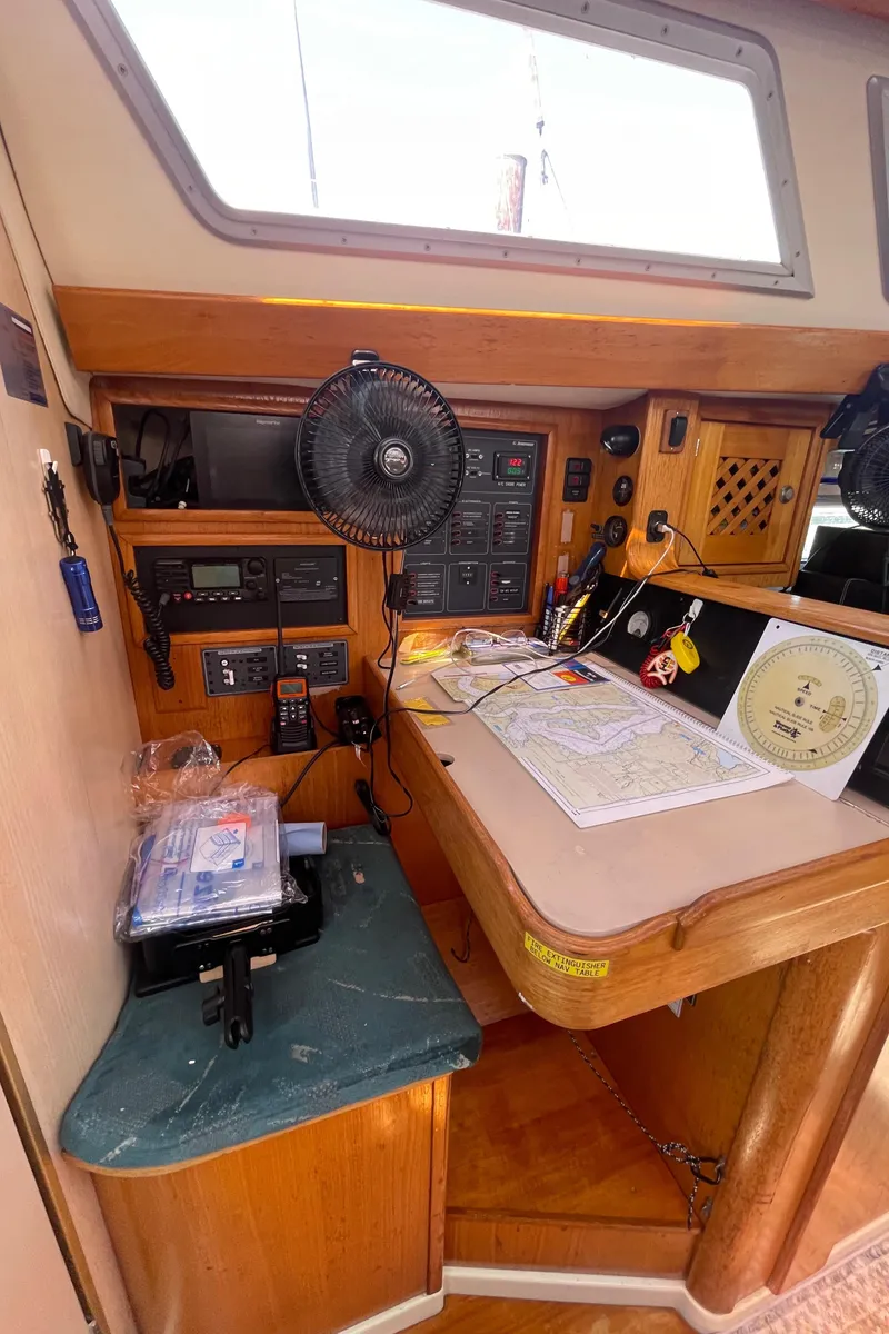 Slide: The Image of Navigation station on 1990 Jeanneau Sun Odyssey 36 sailboat with charts and instruments. - 31