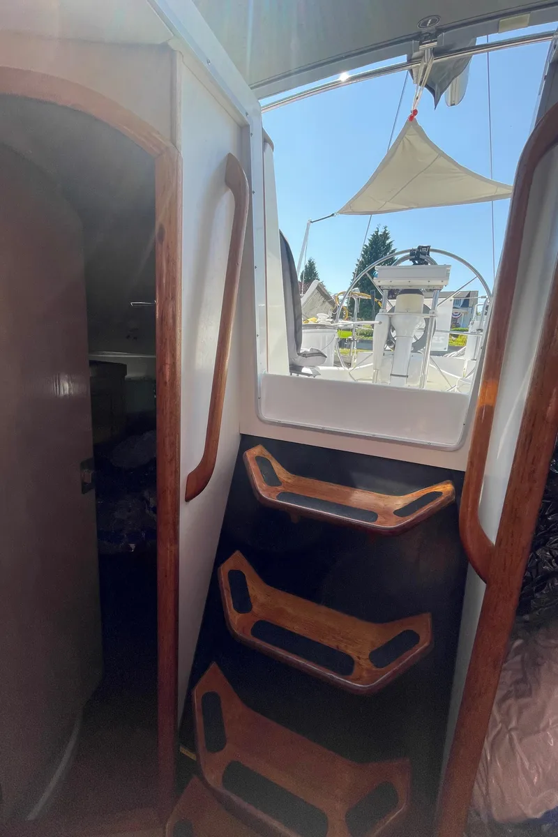 Slide: The Image of Interior view of 1990 Jeanneau Sun Odyssey 36 sailboat with wooden steps and cockpit access. - 35