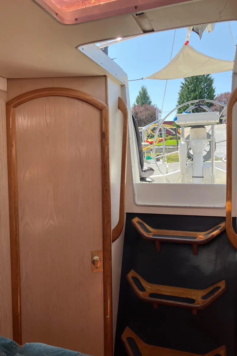 Slide: The Image of Interior view of 1990 Jeanneau Sun Odyssey 36 sailboat, showing cabin door and steps to deck. - 36