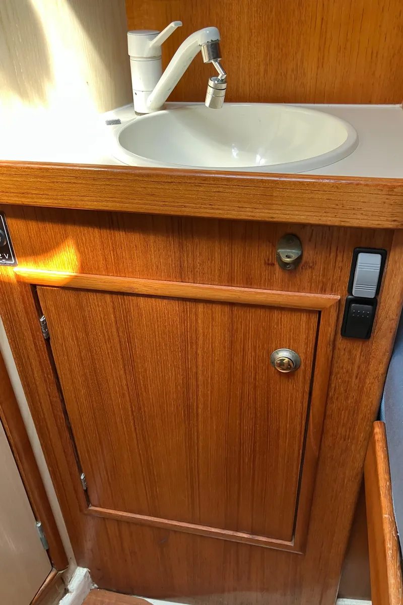 Slide: The Image of Wooden cabinet with sink in 1990 Jeanneau Sun Odyssey 36 yacht interior. - 40