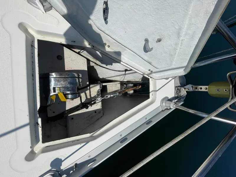 Slide: The Image of Anchor locker of 1990 Jeanneau Sun Odyssey 36 sailboat with visible winch and chain. - 6