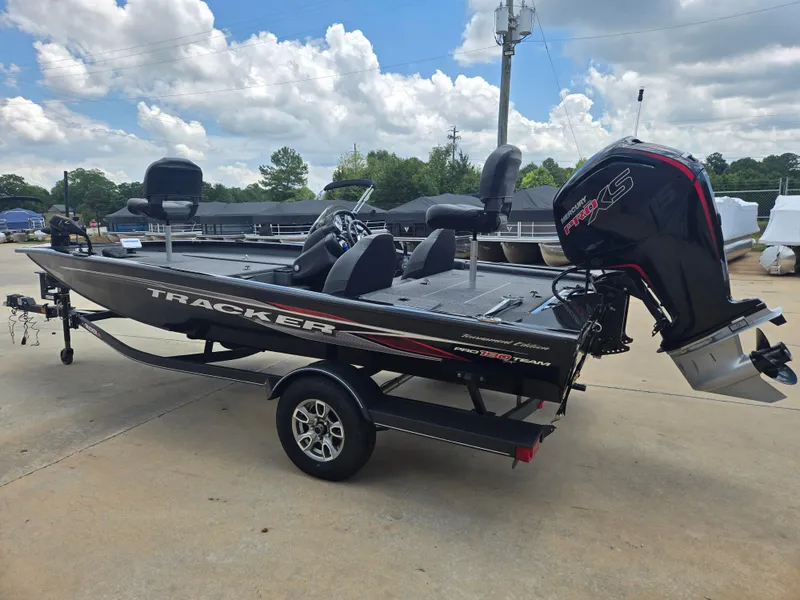 Slide: The Image of 2019 Tracker Pro Team 190 TX Tournament Edition boat on trailer, outdoors under blue sky. - 2