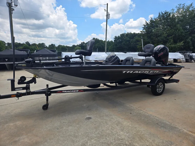 Slide: The Image of 2019 Tracker Pro Team 190 TX Tournament Edition boat on trailer, parked outdoors. - 3