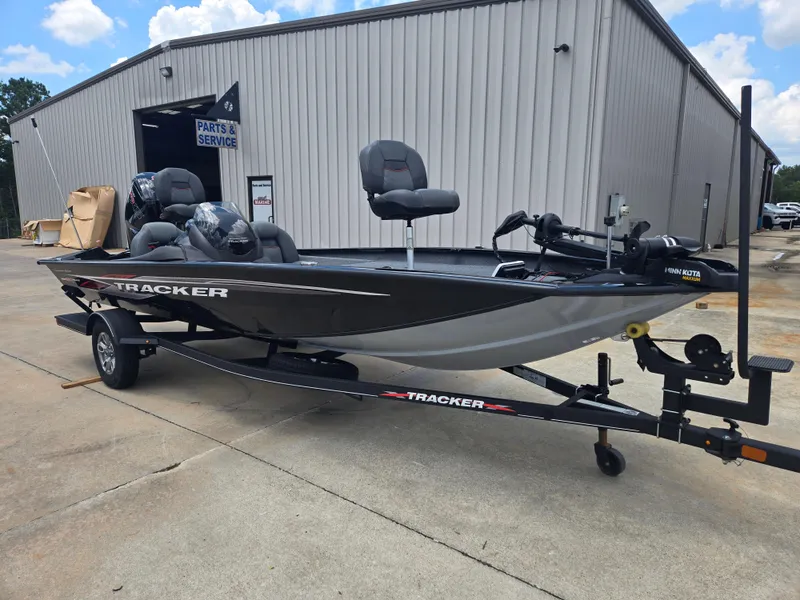 Slide: The Image of 2019 Tracker Pro Team 190 TX Tournament Edition boat on trailer outside service building. - 8