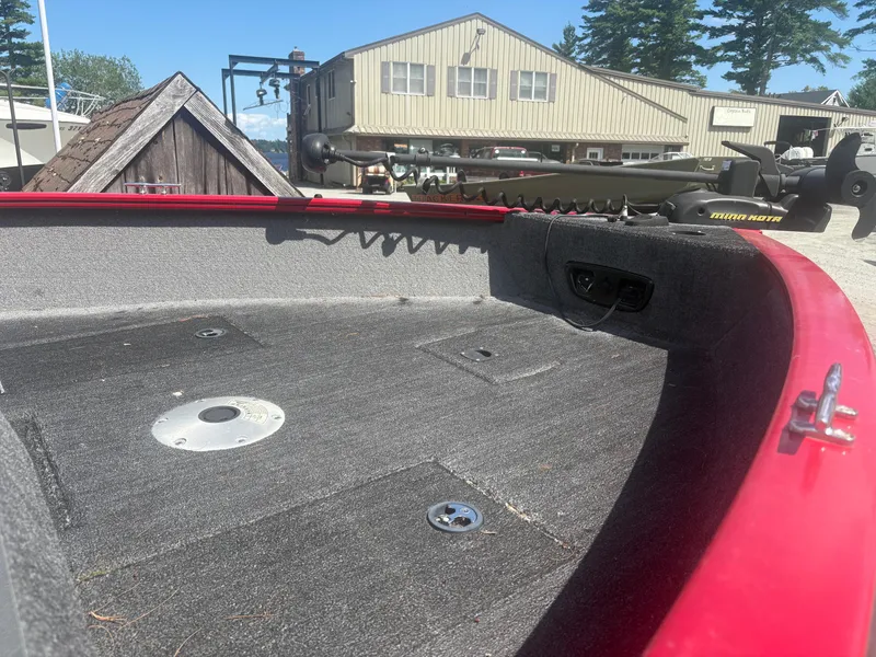 Slide: The Image of 2016 Tracker Pro Guide V-175 SC boat interior with red trim and fishing equipment. - 5