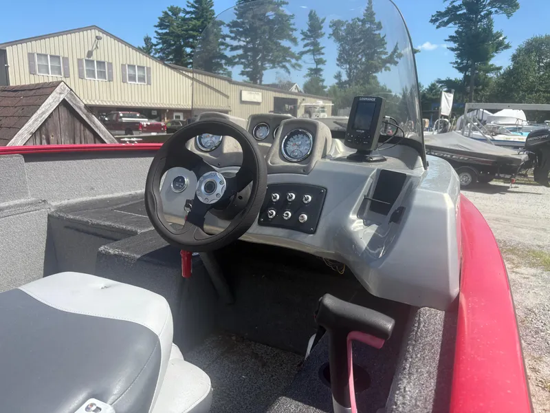 Slide: The Image of 2016 Tracker Pro Guide V-175 SC boat dashboard with steering wheel and controls. - 6
