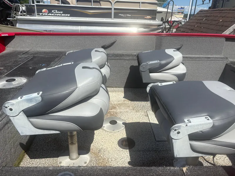 Slide: The Image of 2016 Tracker Pro Guide V-175 SC boat interior with gray seating and fishing deck. - 7