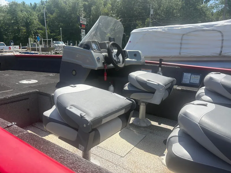 Slide: The Image of 2016 Tracker Pro Guide V-175 SC boat interior with gray seating and steering console. - 8