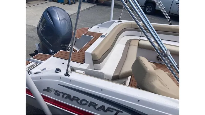 Slide: The Image of 2019 Starcraft MDX 191 O/B boat with Yamaha outboard motor, featuring beige seating and wood accents. - 2