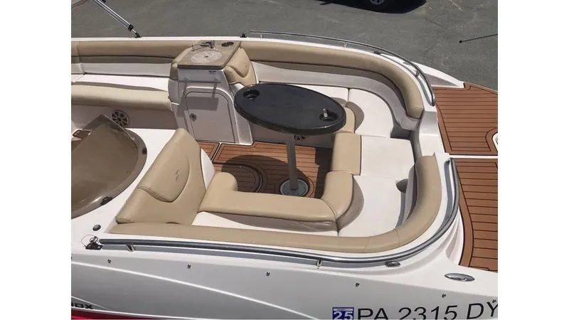 Slide: The Image of 2019 Starcraft MDX 191 O/B boat interior with beige seating and a central table. - 5