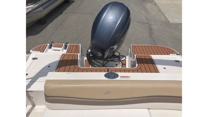 Slide: The Image of 2019 Starcraft MDX 191 O/B boat with outboard motor and teak-style deck. - 9
