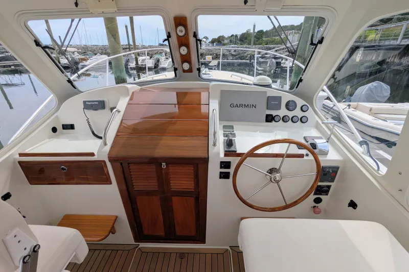 Slide: The Image of 2005 MJM 34z Downeast boat helm with Garmin navigation and wooden steering wheel. - 11