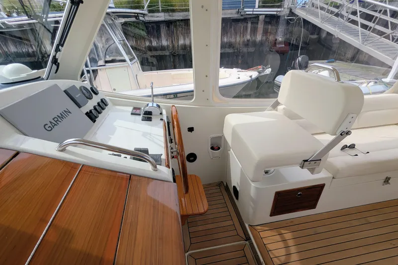 Slide: The Image of 2005 MJM 34z Downeast boat interior with Garmin navigation system and white seating. - 12