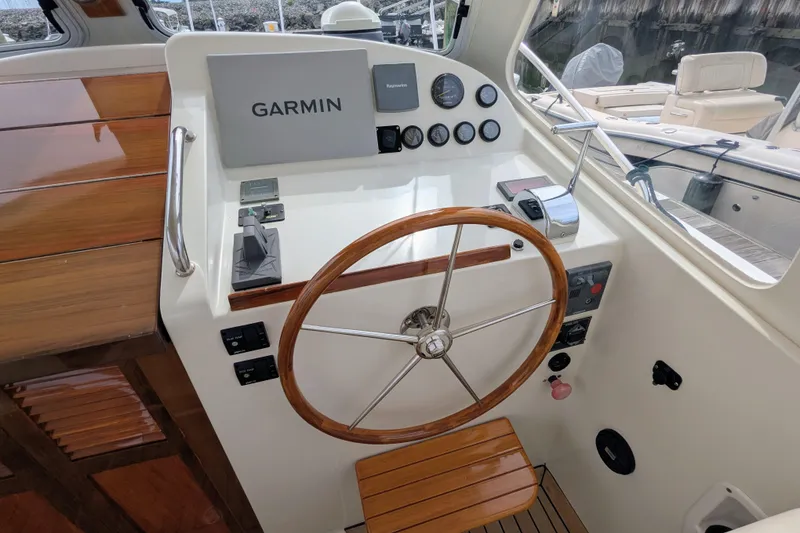 Slide: The Image of Helm of 2005 MJM 34z Downeast boat with Garmin navigation system and wooden steering wheel. - 13