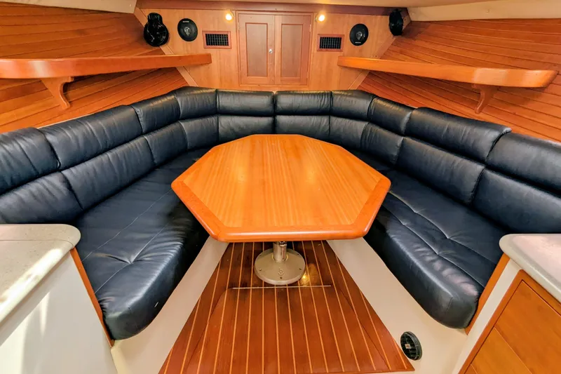 Slide: The Image of 2005 MJM 34z Downeast yacht interior with wood table and leather seating. - 21