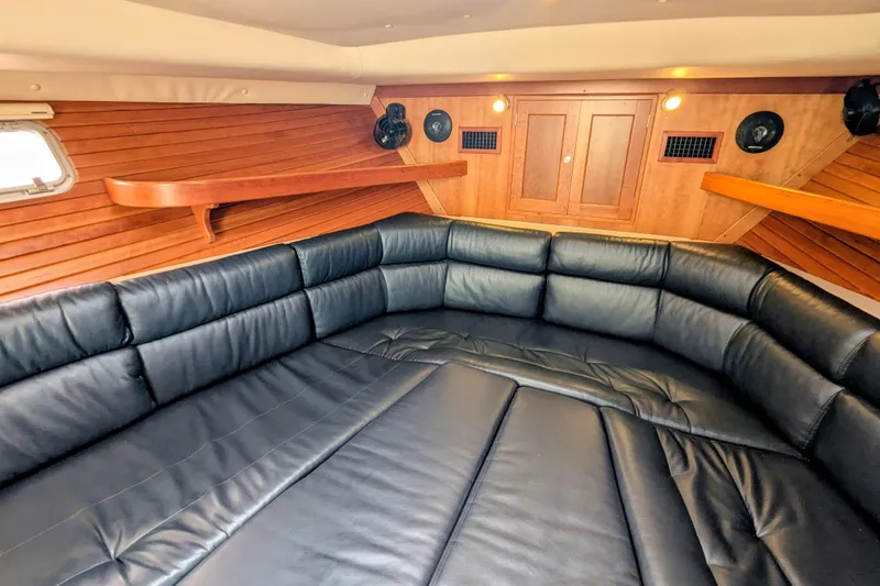Slide: The Image of Luxurious interior of 2005 MJM 34z Downeast with black leather seating and wooden accents. - 23