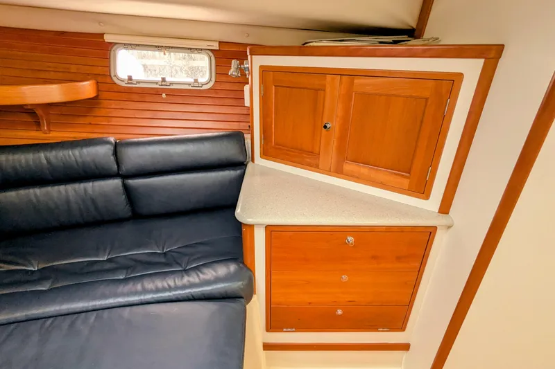 Slide: The Image of Interior of 2005 MJM 34z Downeast boat with wooden cabinets and leather seating. - 24