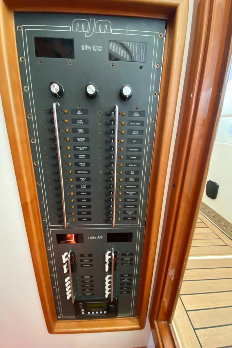 Slide: The Image of Electrical panel of 2005 MJM 34z Downeast boat, featuring switches and controls. - 31
