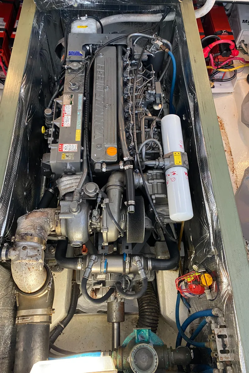 Slide: The Image of Engine compartment of a 2005 MJM 34z Downeast boat, showcasing detailed mechanical components. - 32