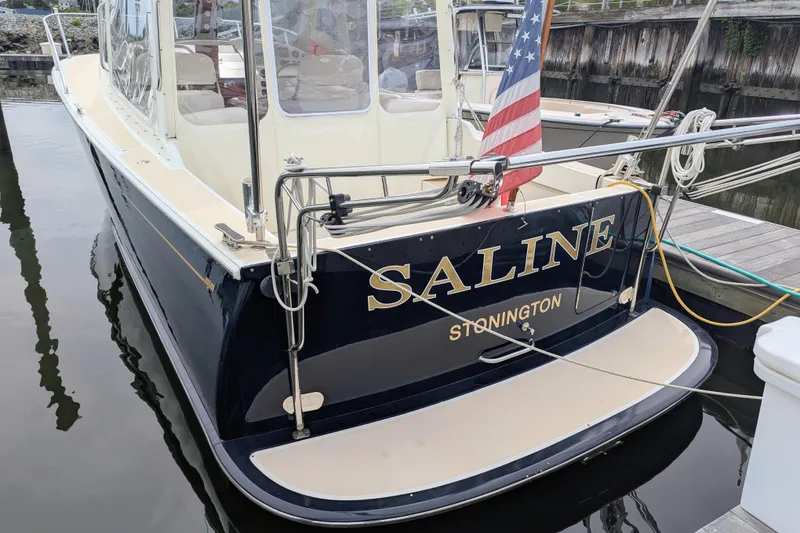 Slide: The Image of 2005 MJM 34z Downeast boat named "Saline" docked with American flag. - 9