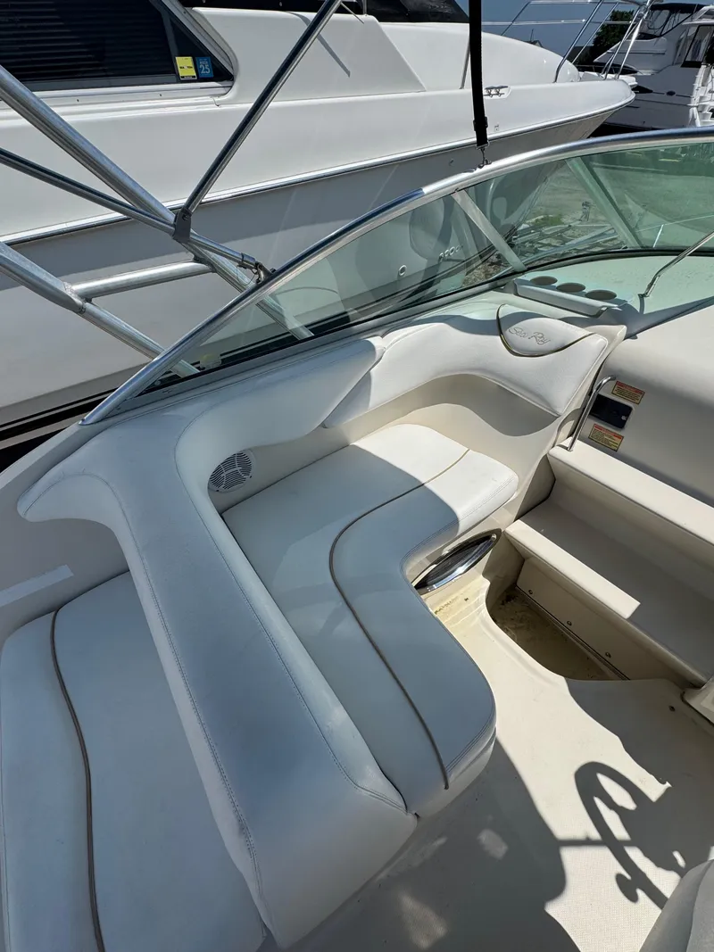Slide: The Image of 2003 Sea Ray 240 Sundancer interior with white seating and sleek design. - 7
