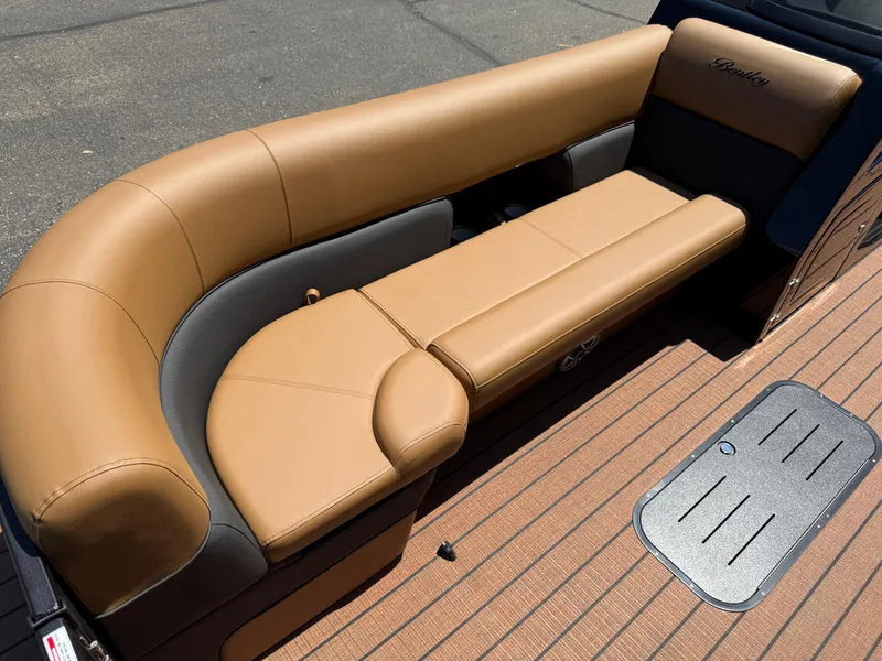 Slide: The Image of 2026 Bentley Pontoons Elite 253 Admiral with tan leather seating and wood-style flooring. - 10