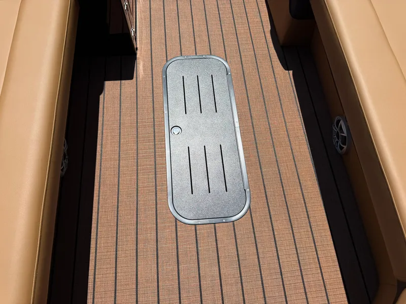 Slide: The Image of 2026 Bentley Pontoons Elite 253 Admiral deck with tan seating and storage hatch. - 12