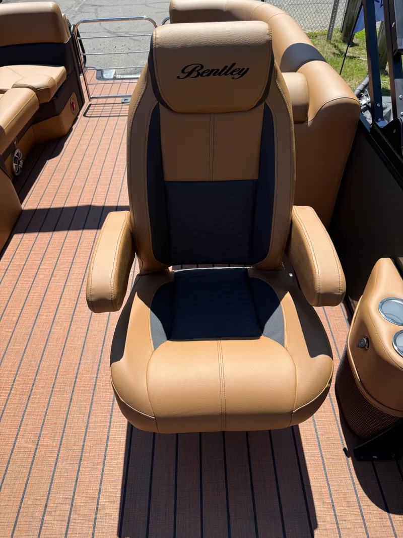 Slide: The Image of 2026 Bentley Pontoons Elite 253 Admiral captain's chair, tan and black upholstery, luxury design. - 17