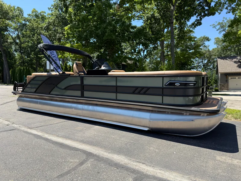 Slide: The Image of 2026 Bentley Pontoons Elite 253 Admiral pontoon boat parked on a sunny day. - 2