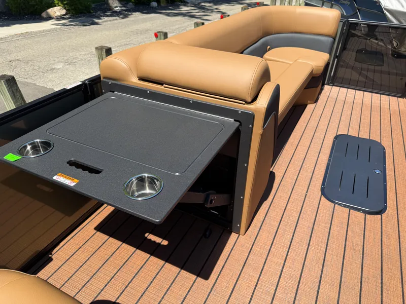 Slide: The Image of 2026 Bentley Pontoons Elite 253 Admiral with tan seating and foldable table on deck. - 20