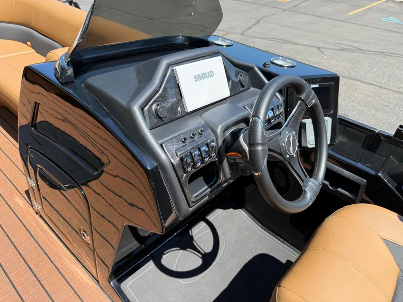 Slide: The Image of 2026 Bentley Pontoons Elite 253 Admiral dashboard with steering wheel and Simrad display. - 22
