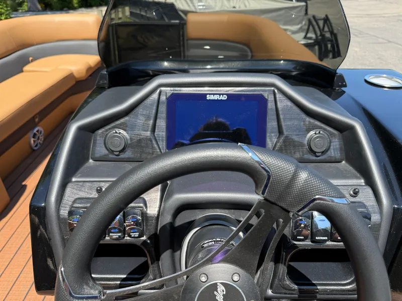 Slide: The Image of Steering console of 2026 Bentley Pontoons Elite 253 Admiral with Simrad display and controls. - 27