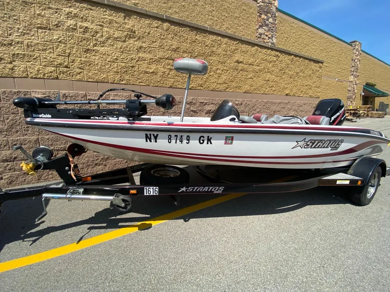 The Image of 2005 Stratos 275 Pro XL boat on trailer, parked outdoors. - 0