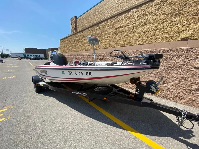 Slide: The Image of 2005 Stratos 275 Pro XL boat on trailer in parking lot, sunny day. - 1