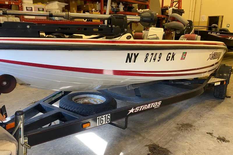 Slide: The Image of 2005 Stratos 275 Pro XL boat on trailer in a storage facility. - 12