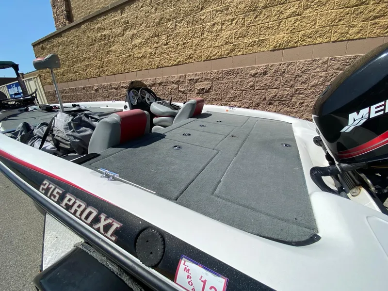 Slide: The Image of 2005 Stratos 275 Pro XL boat with seating and storage, parked outdoors. - 3