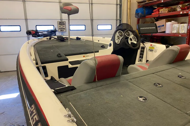 Slide: The Image of 2005 Stratos 275 Pro XL boat interior with steering console and seating in a garage. - 9