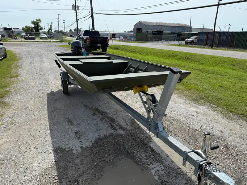 Slide: The Image of 2025 Alweld 1442 MARSH JON DSLW boat on trailer, parked on gravel road. - 6