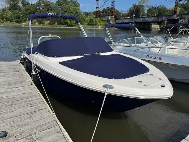 The Image of 2024 Robalo R207 Dual Console boat docked on a calm river. - 0
