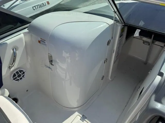 Slide: The Image of 2024 Robalo R207 Dual Console interior with white seating and storage compartment. - 13