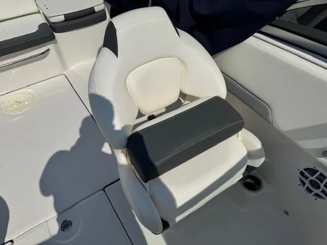 Slide: The Image of 2024 Robalo R207 Dual Console boat seat, white and black upholstery, modern design. - 16