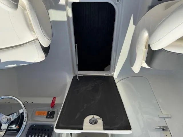 Slide: The Image of 2024 Robalo R207 Dual Console interior with steering wheel and seating. - 18