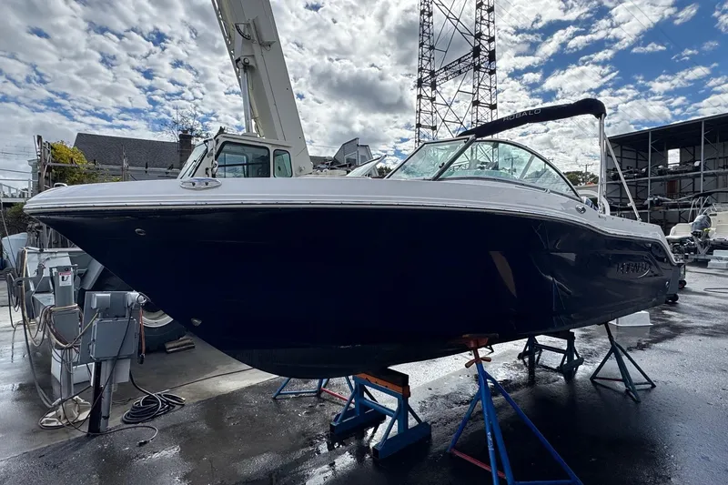 Slide: The Image of 2024 Robalo R207 Dual Console boat on stands in a marina setting. - 23