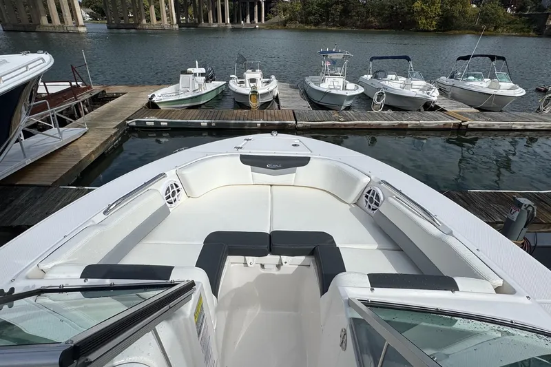 Slide: The Image of 2024 Robalo R207 Dual Console boat docked, featuring spacious seating and sleek design. - 24