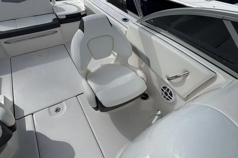 Slide: The Image of 2024 Robalo R207 Dual Console interior with white seating and sleek design. - 28