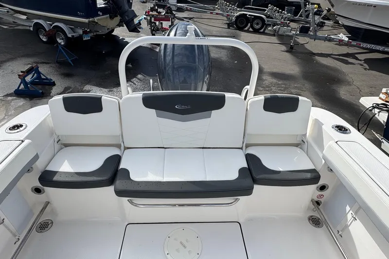 Slide: The Image of 2024 Robalo R207 Dual Console boat interior with seating and cup holders. - 29