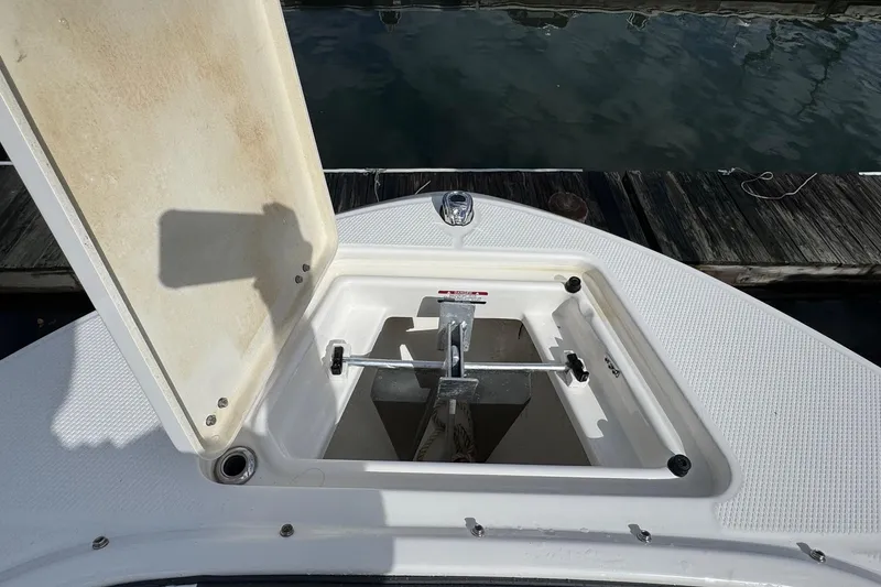Slide: The Image of 2024 Robalo R207 Dual Console anchor compartment open at dock. - 32