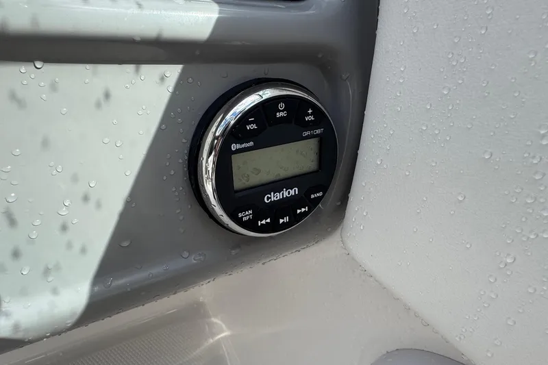 Slide: The Image of Clarion audio system on 2024 Robalo R207 Dual Console, featuring Bluetooth connectivity. - 34